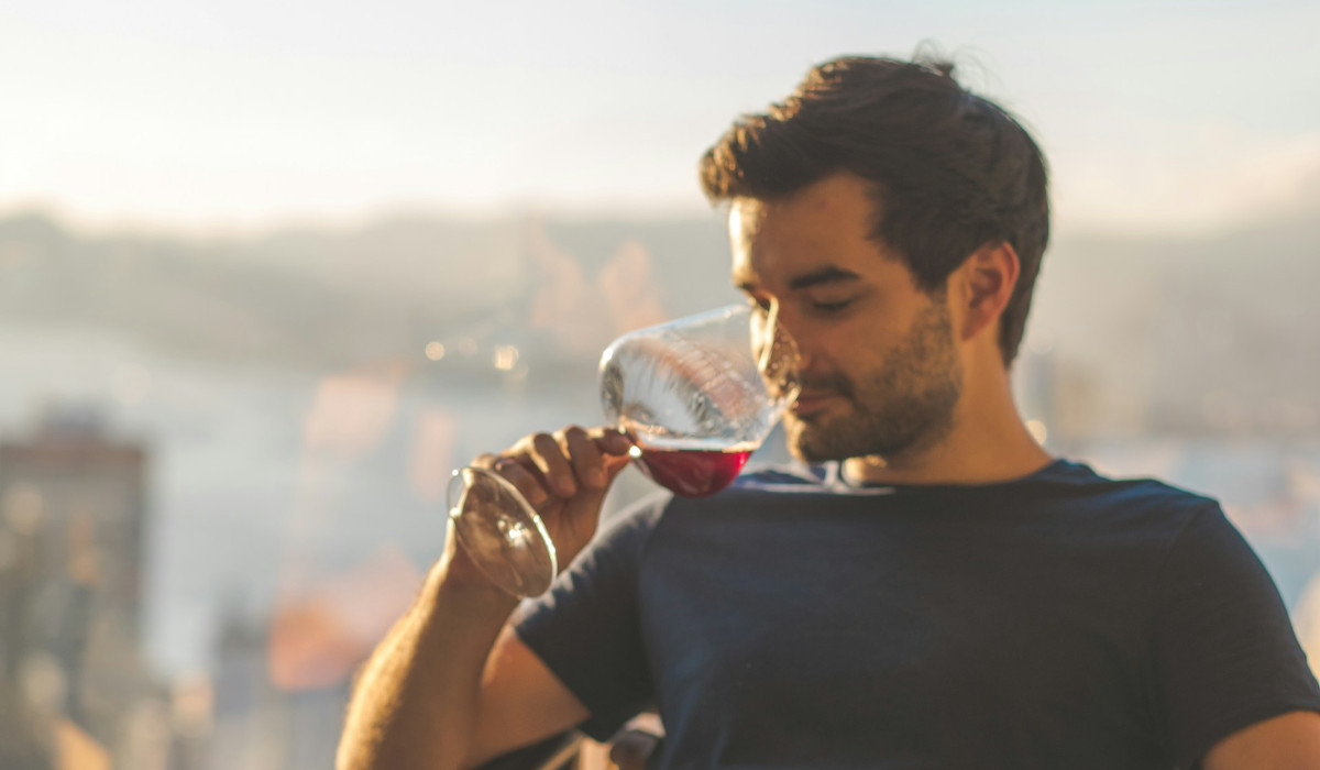 ReSales Blogartikel Rotweinflecken entfernen Mann trinkt ein Glas Rotwein