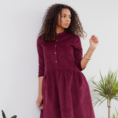 Secondhand Kleider Frau trägt ein rotes Cord-Kleid